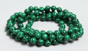 A STRING OF MALACHITE BEADS