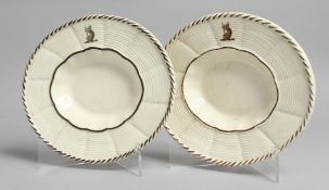 A PAIR OF WEDGWOOD CREAMWARE OVAL BASKET WEAVE DISHES, painted to the border with an armorial.