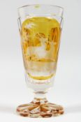 A GOOD BOHEMIAN AMBER GOBLET engraved with panels of deer. 6ins high.