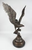 A LARGE BRONZE EAGLE. 36ins high on a circular marble base.