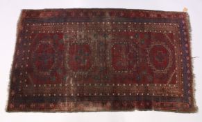 AN EARLY 20TH CENTURY PERSIAN RUG, red ground with stylized design (worn). 7ft x 4ft.