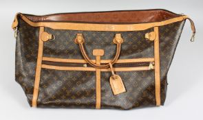 A LARGE LOUIS VUITTON LEATHER BAG. 26ins long, 15ins deep.