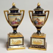A SUPERB SMALL PAIR OF VIENNA URNS, COVERS AND STANDS rich gilt decoration and painted classical