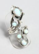 A SILVER AND OPAL NATURALISTIC RING.