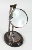 A MAGNIFYING GLASS on a stand.