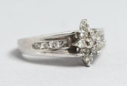 A 10CT GOLD, DIAMOND CLUSTER RING with diamond shoulder