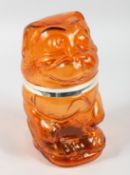 AN AMBER COLOURED GLASS COOKIE JAR.