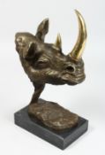 A BRONZE RHINOCEROS HEAD on a marble base. 13ins high.