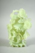 A CHINESE CARVED JADE VASE AND COVER, carved in relief with flowers and vine, 16cm high.