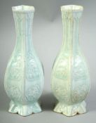 A SMALL PAIR OF CHINESE CELADON GLAZE POTTERY VASES, both of hexagonal form with raised panels of
