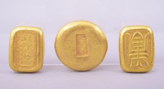 THREE CHINESE GILT BRONZE INGOT PAPERWEIGHTS.