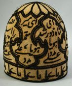 AN EMBROIDERED DERVISH CAP, embroidered all over with calligraphy.