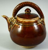 A CHINESE BROWN GLAZE POTTERY TEAPOT AND COVER, the handle moulded as a chilong dragon, 13.5cm