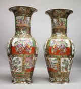 A VERY LARGE PAIR OF CHINESE CANTON FAMILLE ROSE PORCELAIN FLOOR STANDING VASES, decorated with