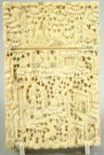 A CHINESE CANTON CARVED IVORY CARD CASE, finely carved with busy village scenes, 11cm x 7.5cm.