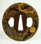 A SMALL JAPANESE SHAKUDO STEEL TSUBA, decorated with a dragon, phoenix and a horse, 6.5cm x 6cm.