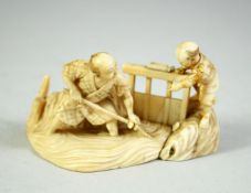 A JAPANESE CARVED IVORY OKIMONO GROUP, depicting a father a son, the father with his feet