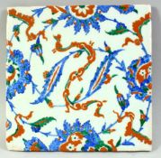 A LARGE TURKISH IZNIK GLAZED POTTERY TILE, decorated with foliate motifs, 25cm square.