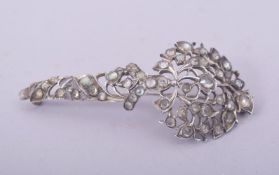 A 19TH CENTURY SRI LANKAN WHITE METAL TURBAN ORNAMENT, 7.5cm long.