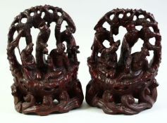 A PAIR OF CHINESE HARDWOOD CARVINGS, depicting eight immortals, each approx 23cm high.