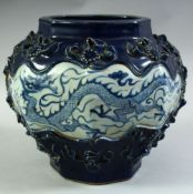 A CHINESE SACRIFICIAL BLUE GROUND OCTAGONAL FORM JAR, with raised floral decoration surrounding
