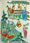 A CHINESE FAMILLE ROSE PORCELAIN PLAQUE, painted with figures in an outdoor setting, two female