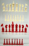 A BURMESE CARVED AND STAINED IVORY CHESS SET, each piece intricately carved, complete, (32 pieces).
