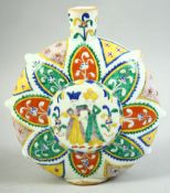 A TURKISH KUTAHYA GLAZED POTTERY WATER FLASK, the centre painted with figures, 21.5cm high.