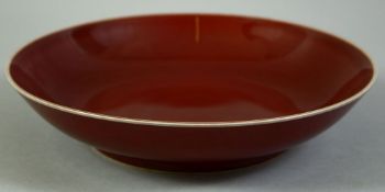 A CHINESE RED GLAZE PORCELAIN DISH, with six character mark to base, 21cm diameter.