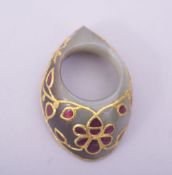 A FINE INDIAN JADE ARCHER'S THUMB RING, inset with coloured stones and gilt metal tracery, 4.5cm.