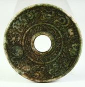 A CHINESE CARVED NEPHRITE JADE ARCHAIC STYLE BI DISK, 12cm diameter.