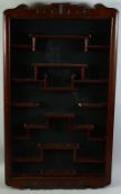A CHINESE HARDWOOD SNUFF BOTTLE WALL DISPLAY CABINET, (lacking glass), 83cm x 48cm.