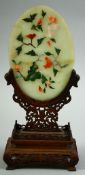 A CHINESE JADE AND HARD STONE OVAL TABLE SCREEN ON WOODEN STAND, the carved jade plaque onlaid