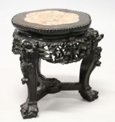 A SMALL CHINESE HARDWOOD AND MARBLE INSET STAND, with shaped top, carved and pierced frieze on three
