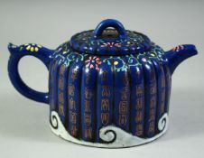 A CHINESE BLUE GLAZED YIXING TEAPOT, the ribbed teapot with characters and floral motifs, the base