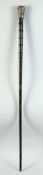 A 19TH CENTURY INDIAN SECTIONAL RHINO HORN WALKING STICK, with silver top, 85cm high.
