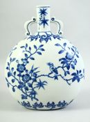A CHINESE BLUE AND WHITE TWIN HANDLE MOON FLASK, decorated with a bird on a tree, 29cm high.