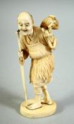 A JAPANESE CARVED IVORY OKIMONO, of a fisherman feeding a small fish to a bird upon his back, the