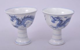 A PAIR OF CHINESE BLUE AND WHITE PORCELAIN STEM CUPS, the exterior decorated with dragons, 8.5cm