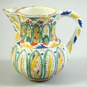 A TURKISH KUTAHYA COFFEE POT, decorated with stylised leaf motifs, 12.5cm high.