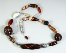 A GOOD LARGE AGATE BEADED NECKLACE, comprising of 21 beads of various forms and sizes, largest