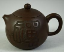A SMALL CHINESE YIXING TEAPOT, with incised characters to the side and impressed mark to base,