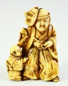 A JAPANESE CARVED IVORY NETSUKE, of a noh actor with a child by his side, 4.5cm high.