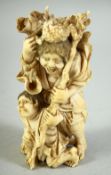 A JAPANESE CARVED IVORY OKIMONO, of a hunched figure holding a staff, the figure with a load upon