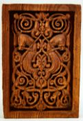 AN ISLAMIC CARVED WOODEN PANEL, with central horse motif, 31.5cm x 21.5cm.