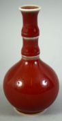 A SMALL CHINESE RED GLAZE BOTTLE VASE, 12cm high.