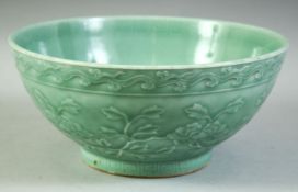A LARGE CHINESE CELADON GLAZE PORCELAIN BOWL, with floral decoration, the inner rim with greek key