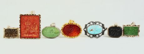 SIX ISLAMIC ENGRAVED WHITE METAL ENCASED SEALS, of various stones, together with a turquoise stone