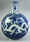 A CHINESE BLUE AND WHITE PORCELAIN MOONFLASK, decorated with incised white dragon against blue