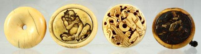 FOUR JAPANESE CARVED IVORY MANJU NETSUKES, one carved with a seated oni, signed to the reverse,